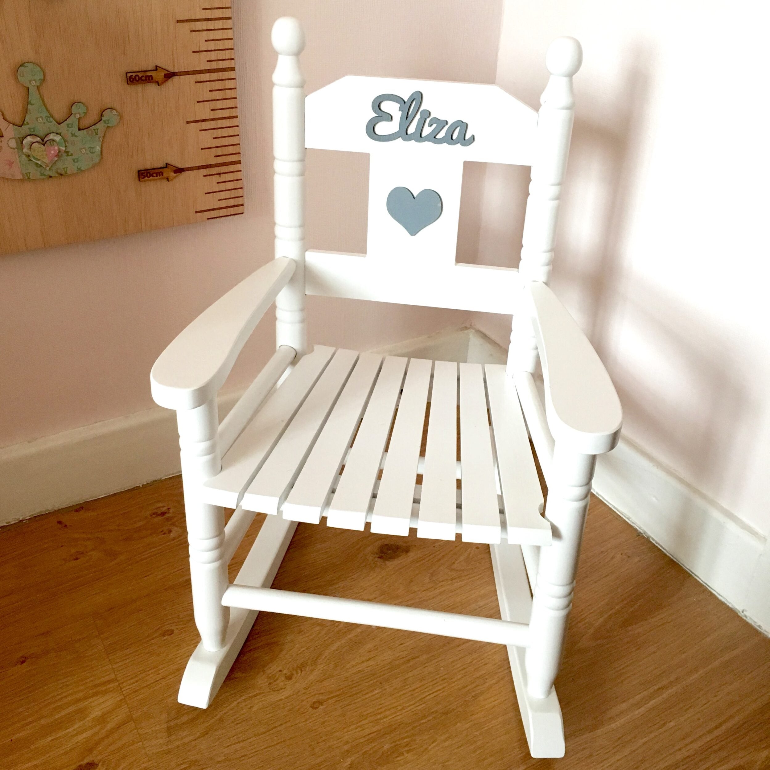 Personalised white wooden children’s rocking chair with decorative name lettering and bow