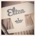 Personalised white wooden children’s rocking chair with decorative name lettering and bow