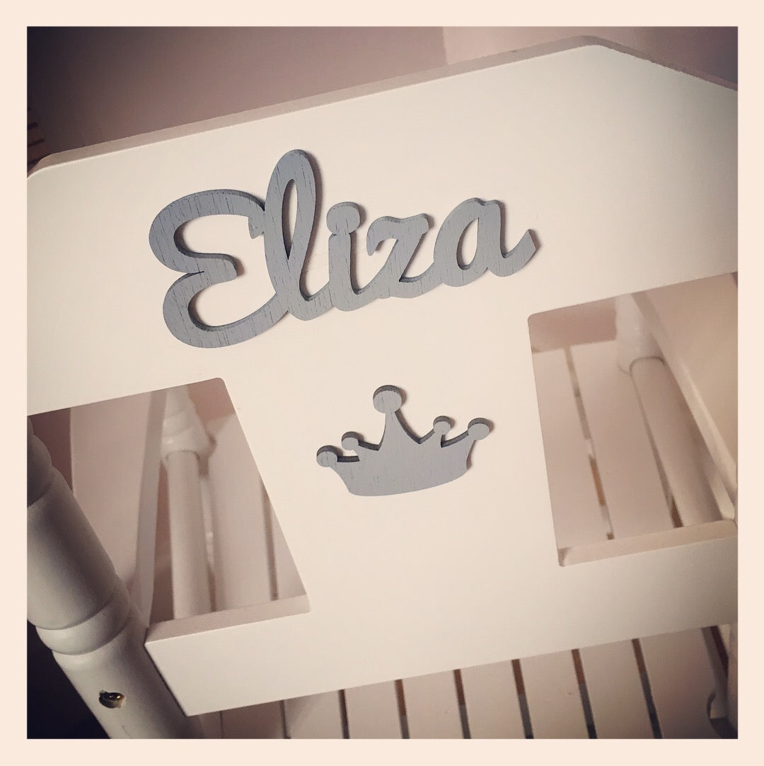 Personalised white wooden children’s rocking chair with decorative name lettering and bow