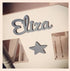 Personalised white wooden children’s rocking chair with decorative name lettering and bow