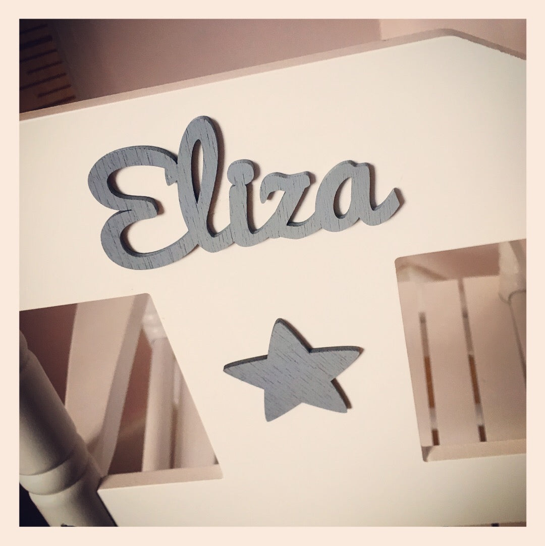 Personalised white wooden children’s rocking chair with decorative name lettering and bow