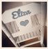 Personalised white wooden children’s rocking chair with decorative name lettering and bow