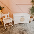 Personalised white wooden children’s rocking chair with decorative name lettering and bow