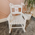 Personalised white wooden children’s rocking chair with decorative name lettering and bow