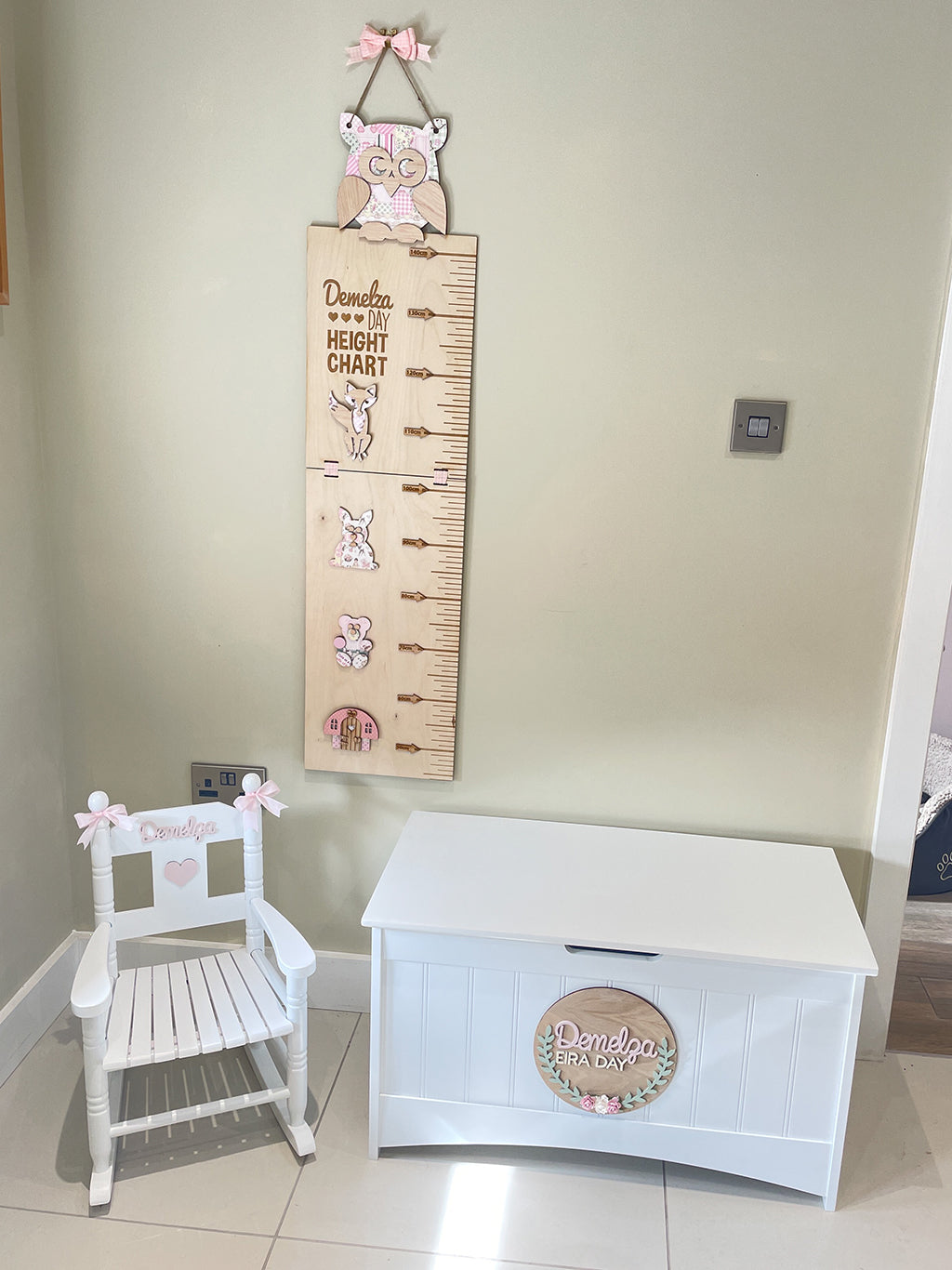Personalised white wooden children’s rocking chair with decorative name lettering and bow